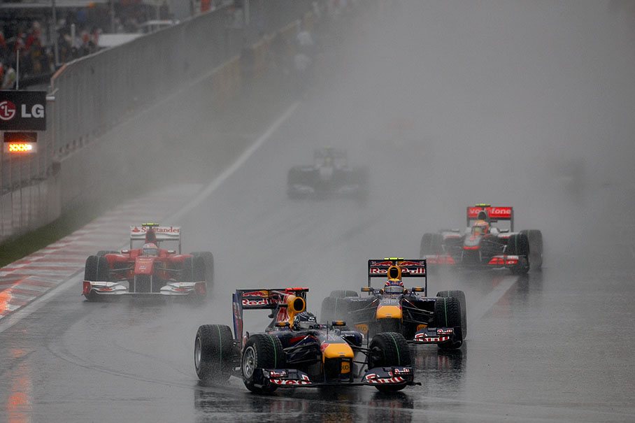 A rainy grid of a brand new race track, the start with the two Red Bull-Renaults in the lead behind the safety car