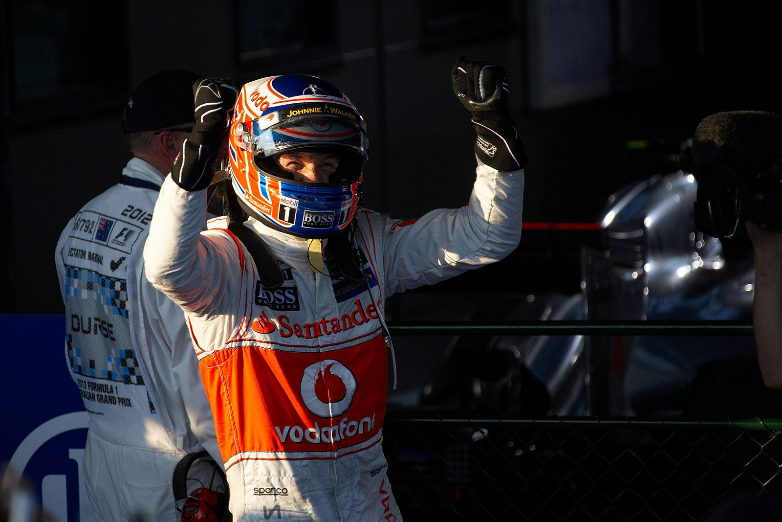 Race winner Jenson Button of McLaren celebrates his achievement in parc ferme
