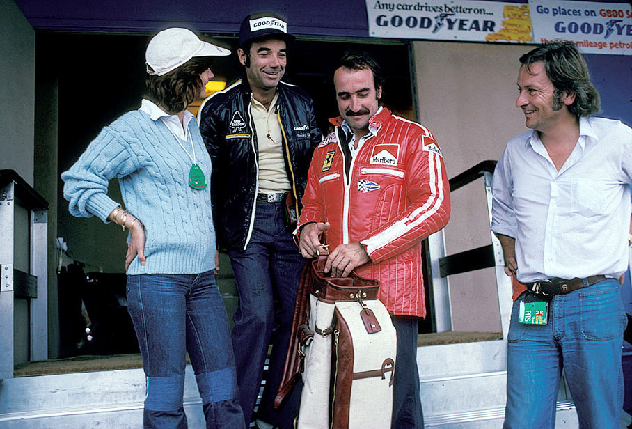 Goodyear PR consultant Bernard Cahier hands over a golf bag as a gift to Ferrari's driver Clay Regazzoni