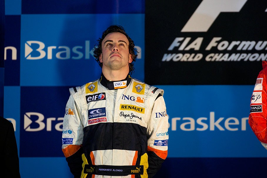 Fernando Alonso listens to the national anthem during podium ceremony