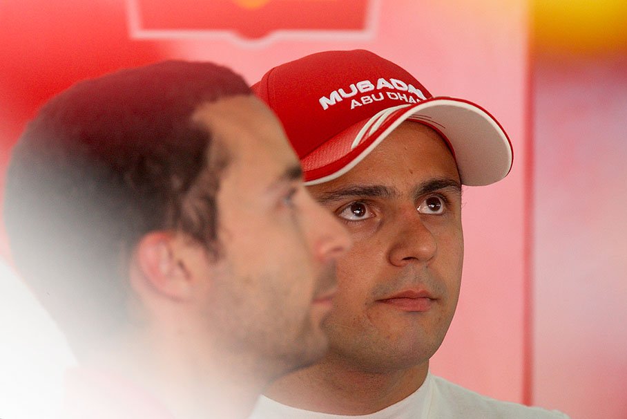 A thoughtful Felipe Massa in Ferrari pits with his manager Nicolas Todt