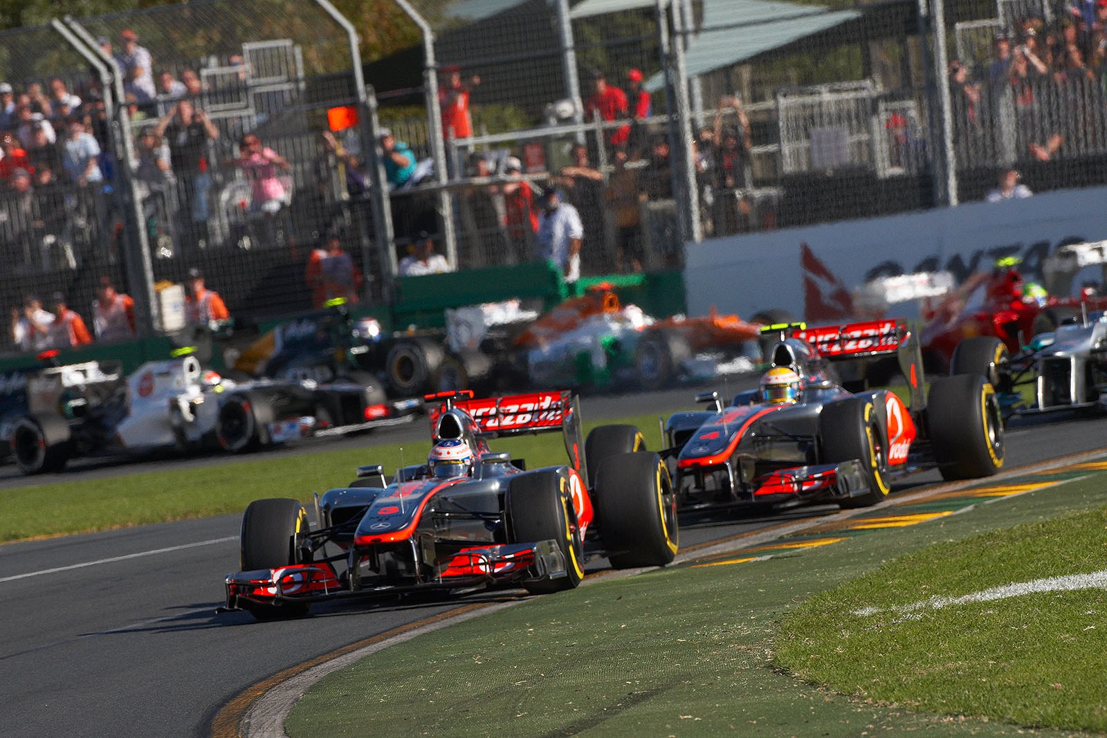 McLarens Jenson Button has a good start and rushes in front of his team mate Hamilton who started from pole position