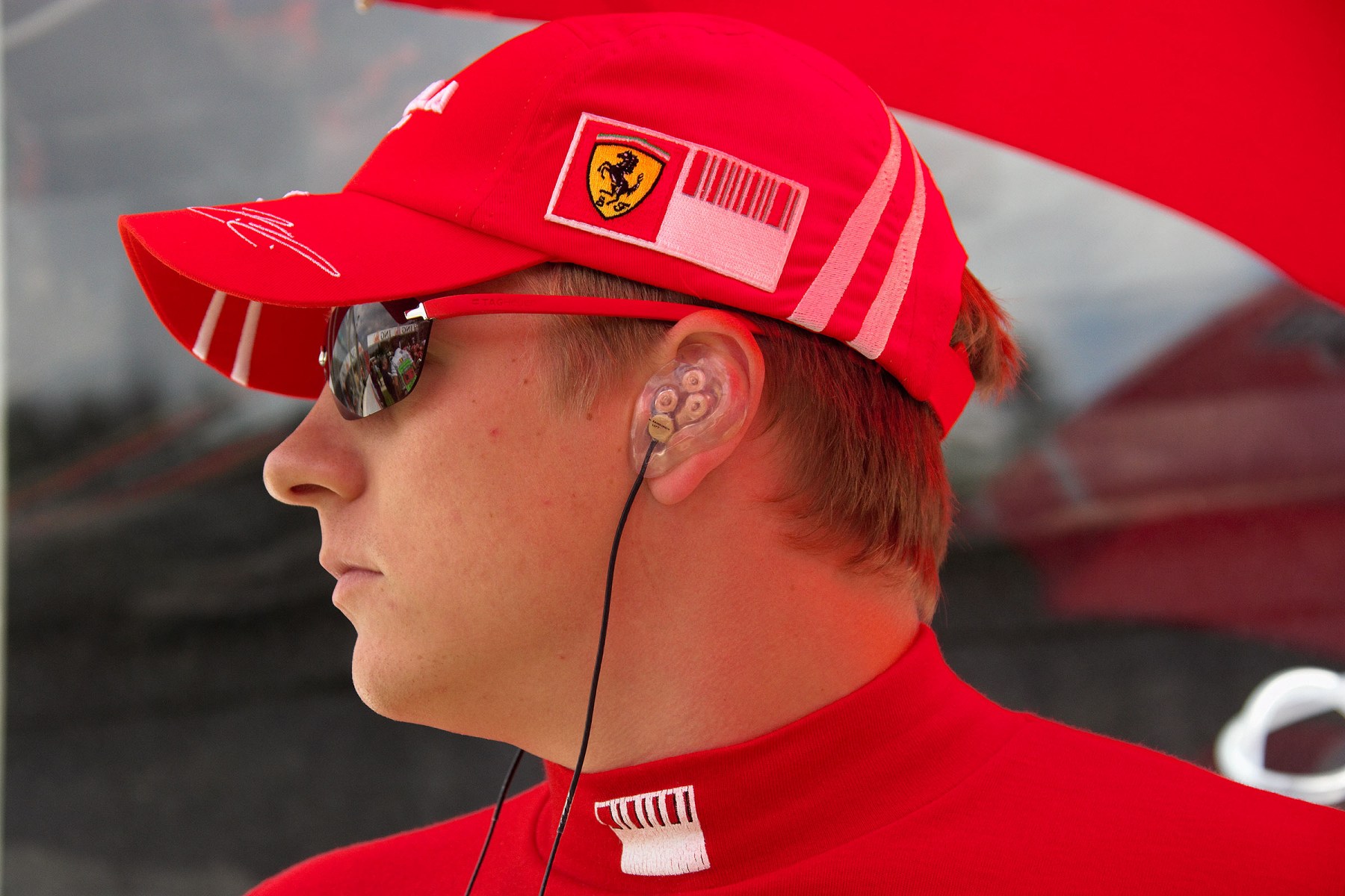 On the grid: Kimi Raikkonen with earphones