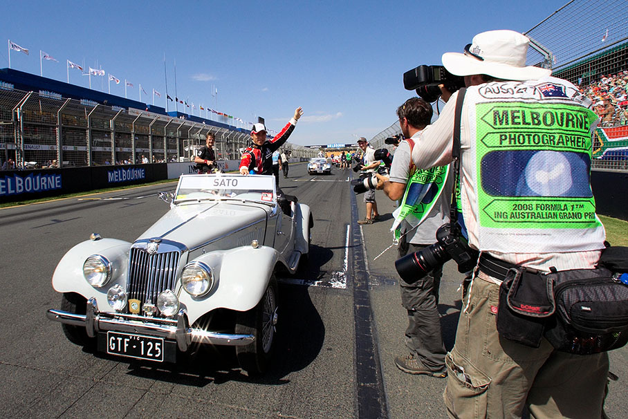 Takuma Sato greets the fans alongside the grid