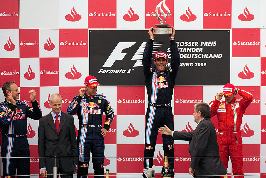 Race winner Mark Webber raises his first first place trophy