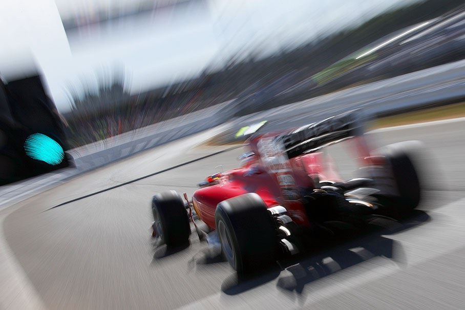Fernando Alonso, Ferrari, passes the green signals at pit lane exit