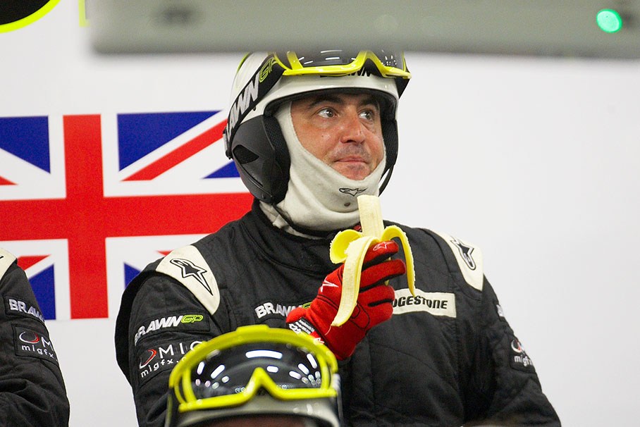 A mechanic takes a heathy snack in Brawn GP pits
