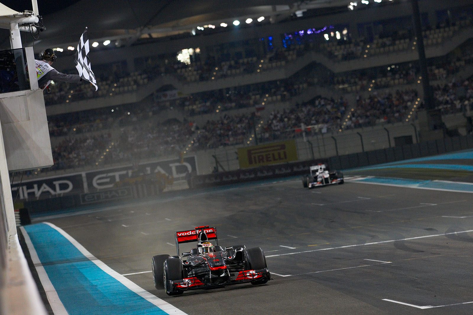 Lewis Hamilton of McLaren Mercedes takes the chequered flag and wins the Abu Dhabi Grand Prix