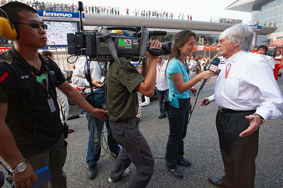 Bernie Ecclestone gives an interview on the grid for a national TV station