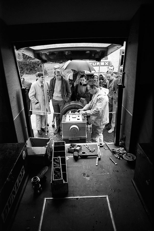 Under the eyes of interested fans, Dunlop mechanics prepare tyres behind their service truck