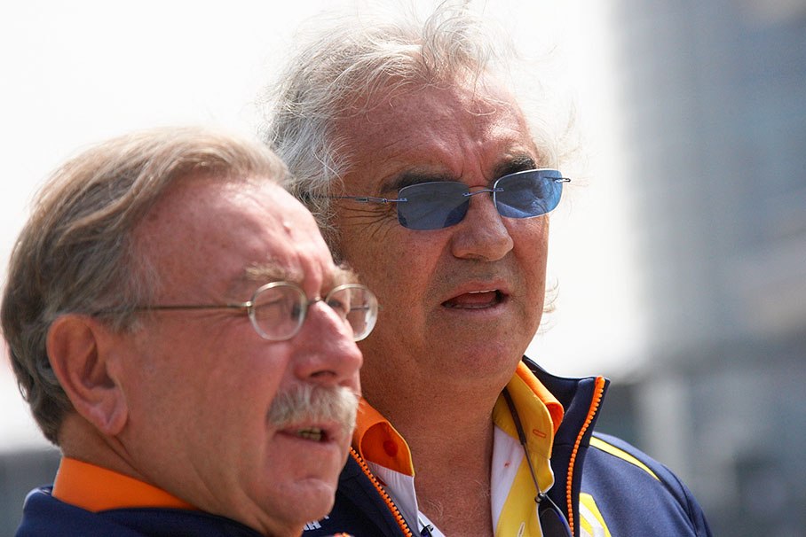 Renault spokesperson Jean-Francois Caubet listens to Renault F1 team boss Flavio Briatore