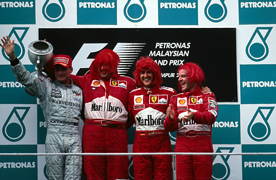 The Ferrari team of Ross Brawn, Michael Schumacher and Rubens Barrichello sporting a red wig to celebrate their drivers and constructors championships achievements.