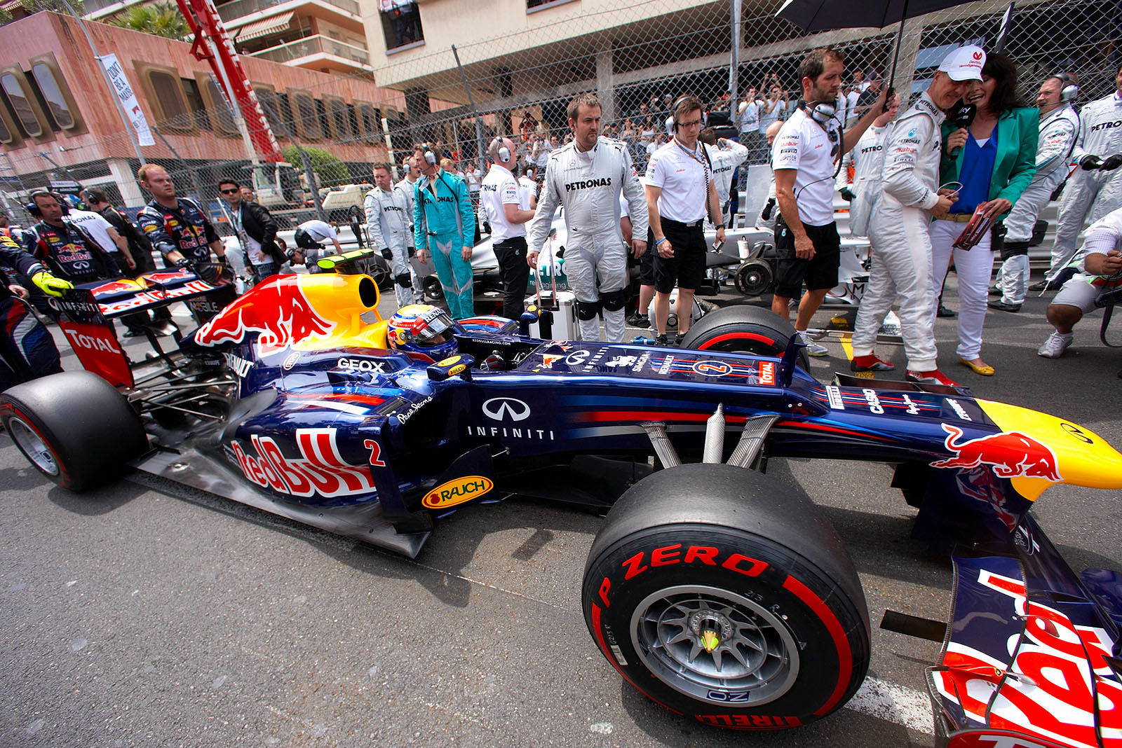 Mark Webber, Red Bull Racing, is pushed to first position on the grid, jealously watched by polesetter Micheal Schumacher who had to go back five places because of an FIA penalty after the Spanish GP