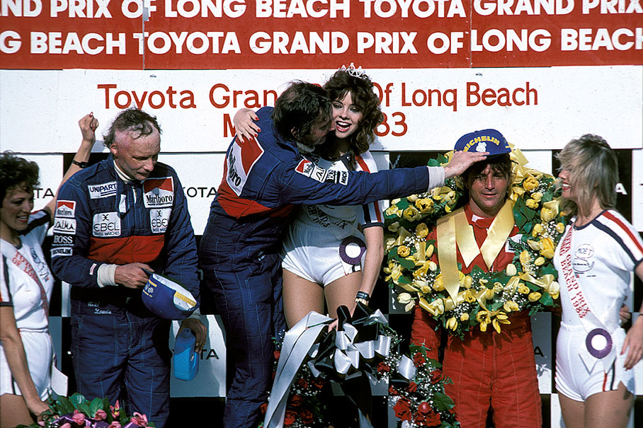 Winner John Watson on the podium, flanked by McLaren team mate Niki Lauda and third placed René Arnoux, who just recveives the right sponsor cap