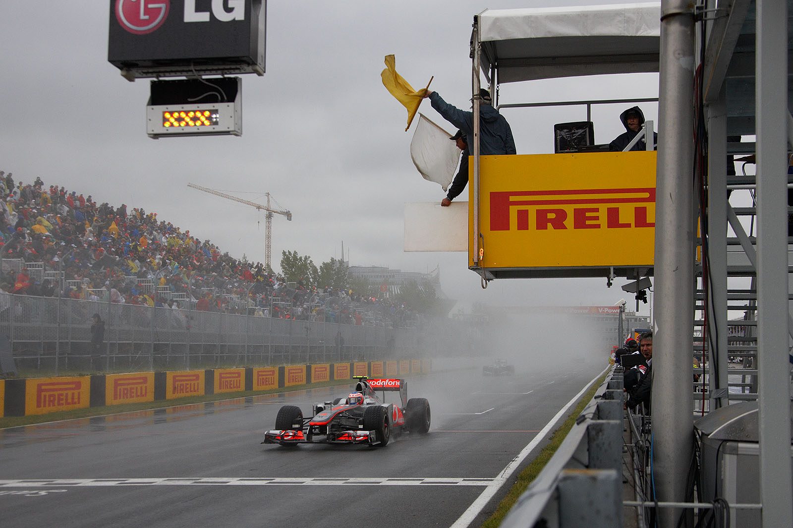 The race is re-started behind the safety car, Jenson Button follows