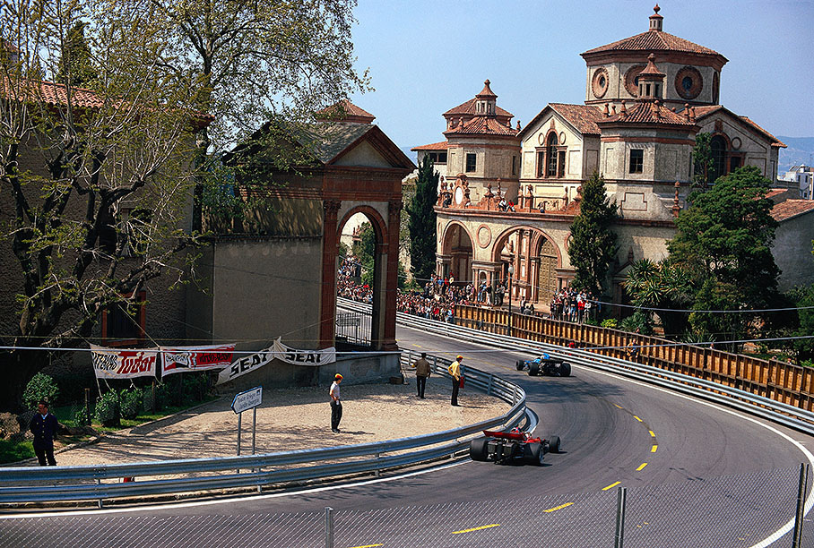 Spanish Grand Prix 1971 at Montjuich Park, a street circuit located on the Montjuich mountain in Barcelona. Fittipaldi's Lotus (red car) and Amon's Matra passing the "Mercat de les Flors".