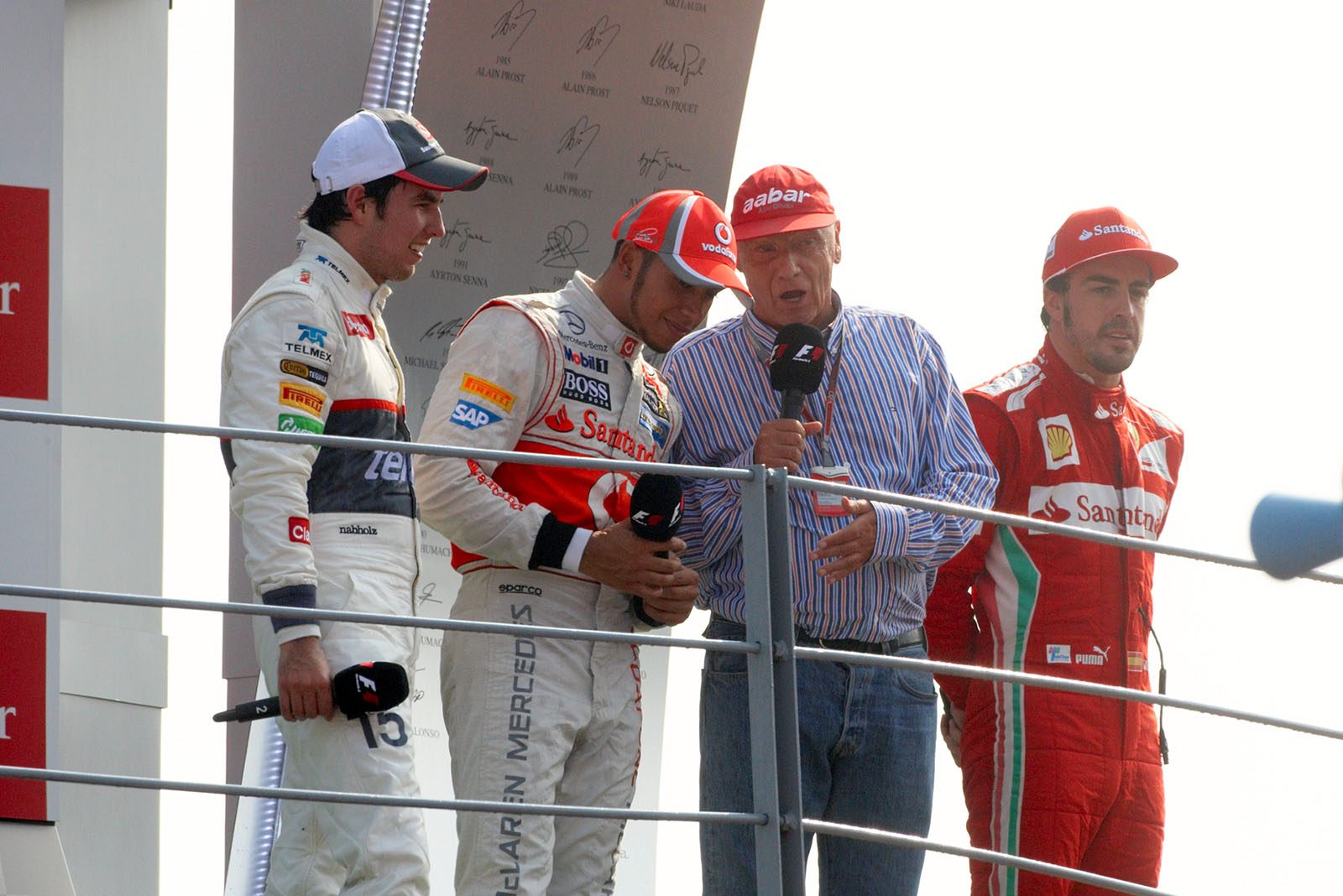 Niki Lauda interviews the race drivers Perez, Hamilton and Alonso after the podium ceremony