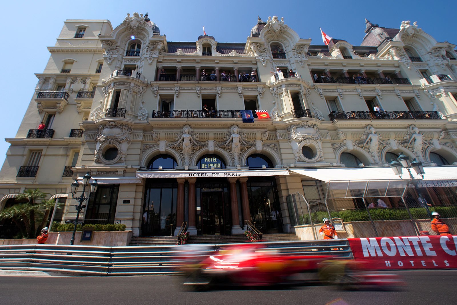 Fernando Alonso's Ferrari passes Monaco's famous Hôtel de Paris
