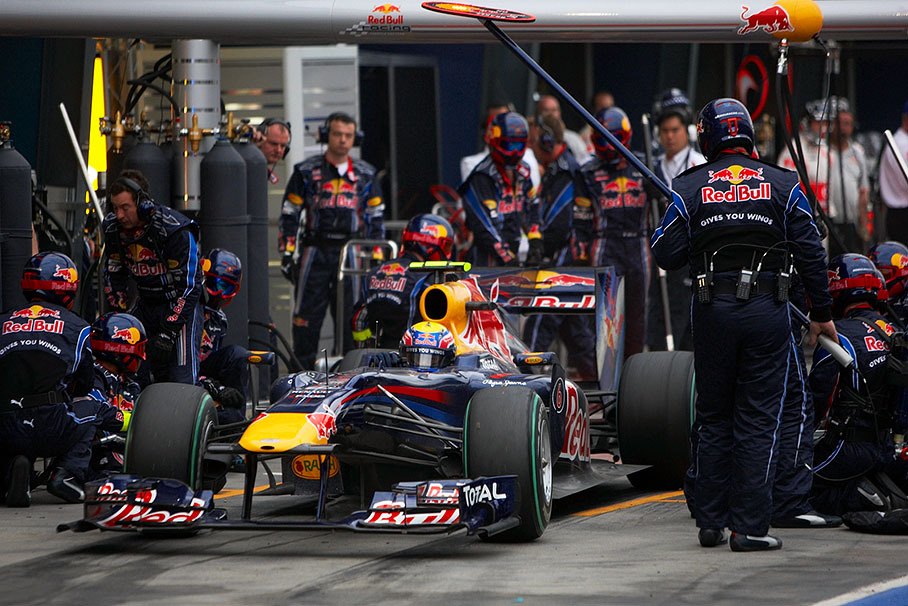 Webber boosts from pits with a new nose cone after a collision with Hamilton in lap 56