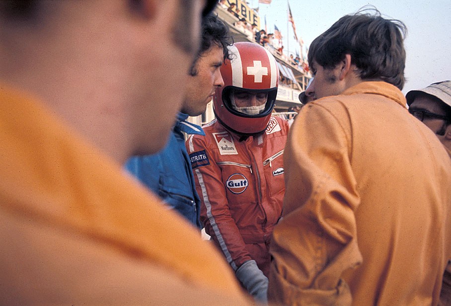 Brian Redman (GB) watches team mate Jo Siffert (CH) getting ready at Porsche pits