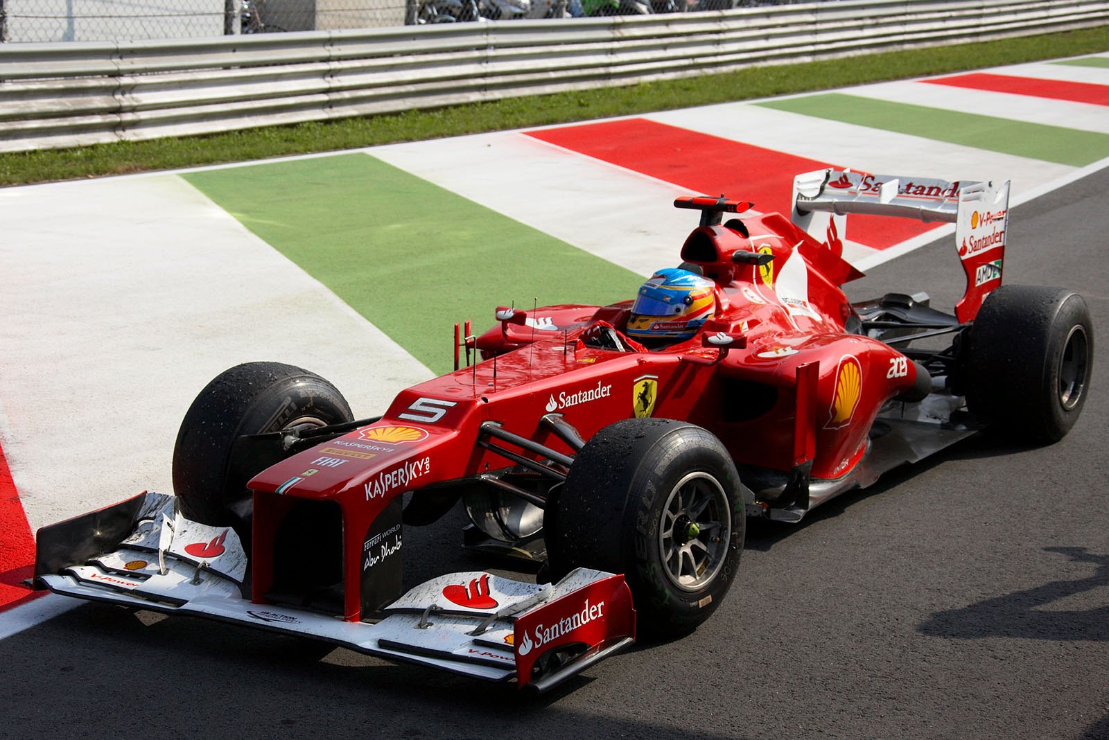 Third placed Fernando Alonso of Ferrari returns from his lap of honour after the race
