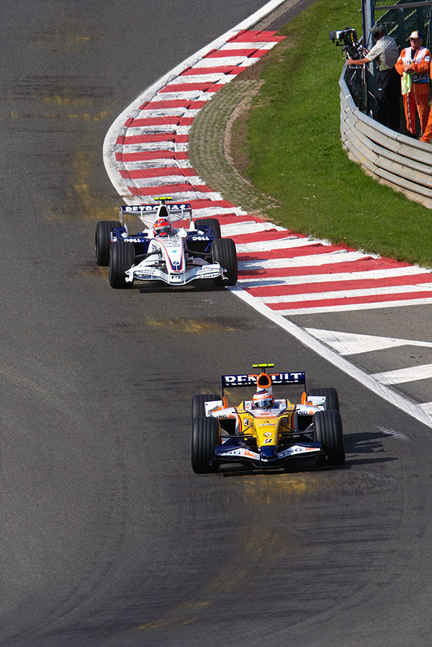 Kovalainen flies through Eau Rouge with Robert Kubica close behind. The stains on the track come from the wooden underbody boards