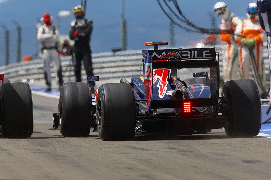 Webber brakes hard at pitlane exit to let Raikkonen's Ferrari pass by