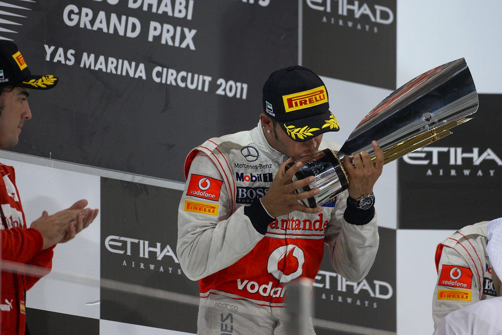 Race winner Lewis Hamilton of McLaren Mercedes kisses his trophy after the Abu Dhabi Grand Prix