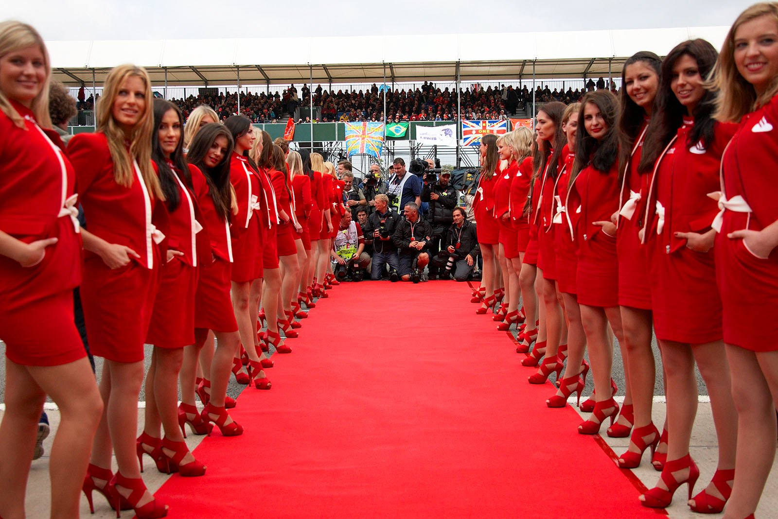 The pretty German grid girls are lined up for the drivers parade, the snappers wait at the end