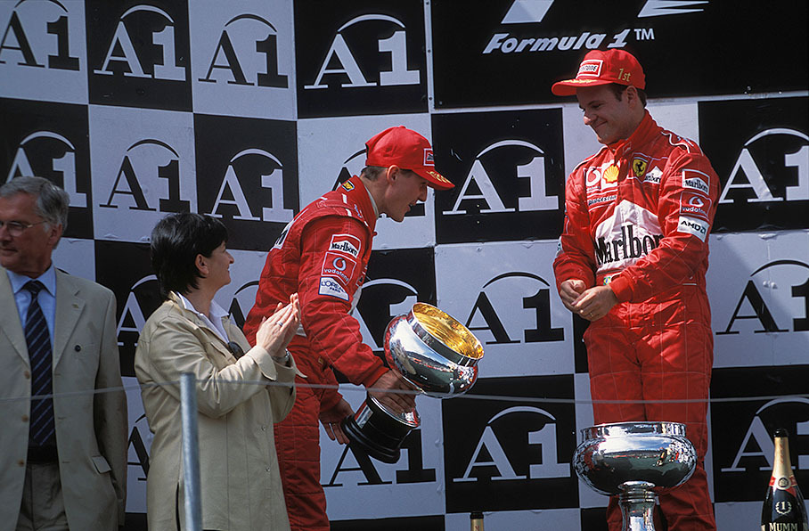 Michael Schumacher bows to Rubens Barrichello