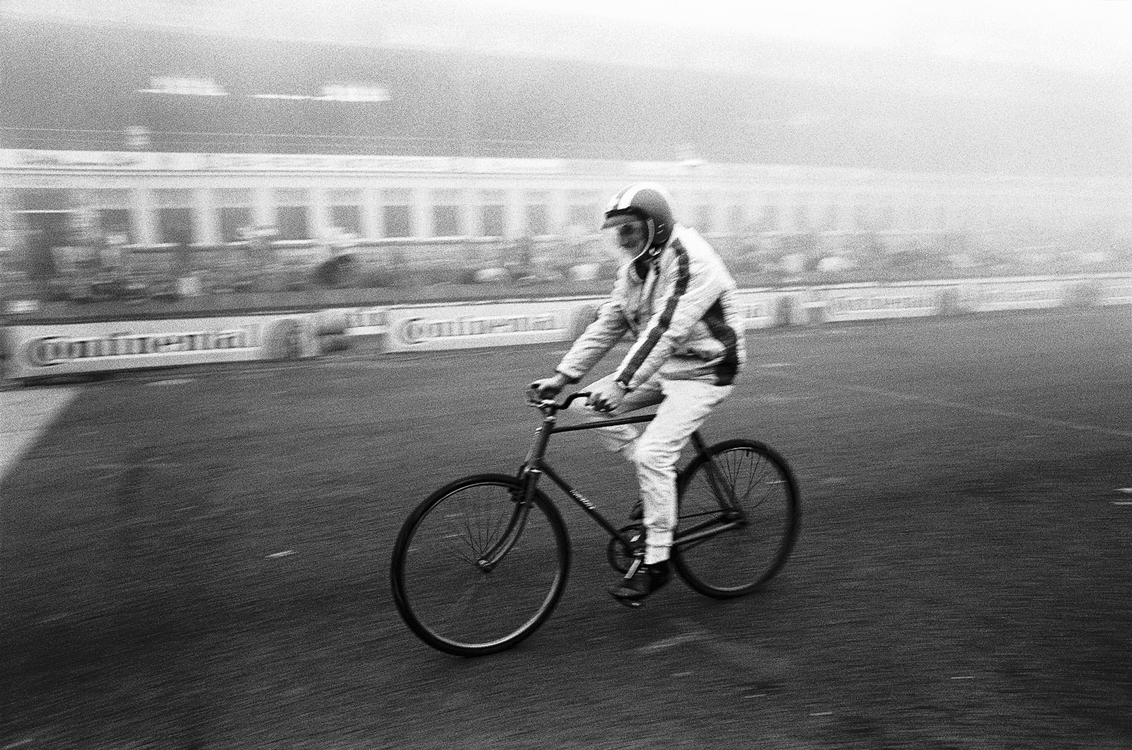 Before the German Grand Prix 1968, Jo Siffert appreciates an informal lap on a bike