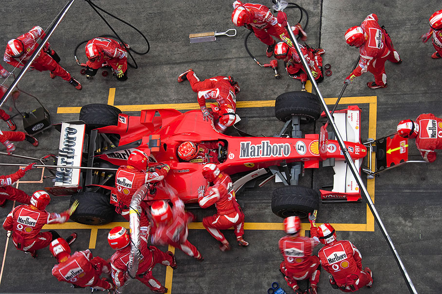 Michael Schumacher performing his first pit stop in lap 21