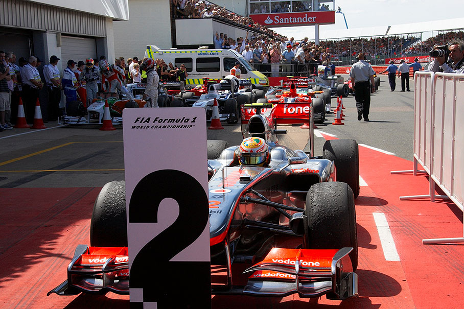 Second placed Hamilton arrives at parc ferme after the race