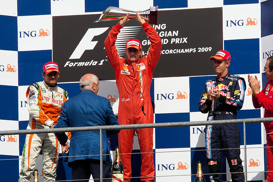 Race winner Kimi Raikkonen lifts his deserved trophy