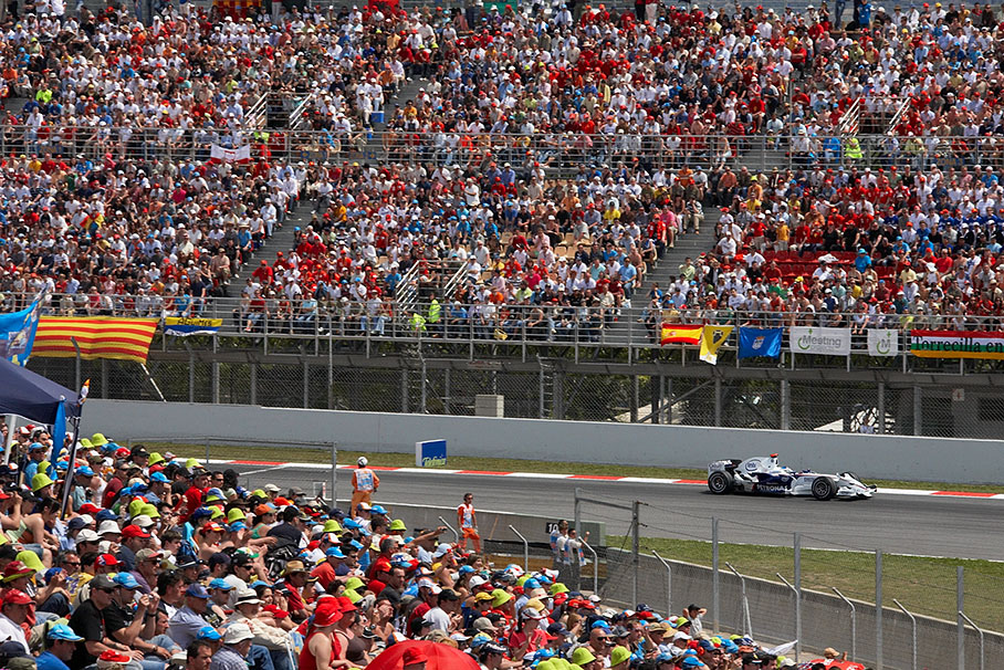 Nick Heidfeld huns through the fan-filled grandstands