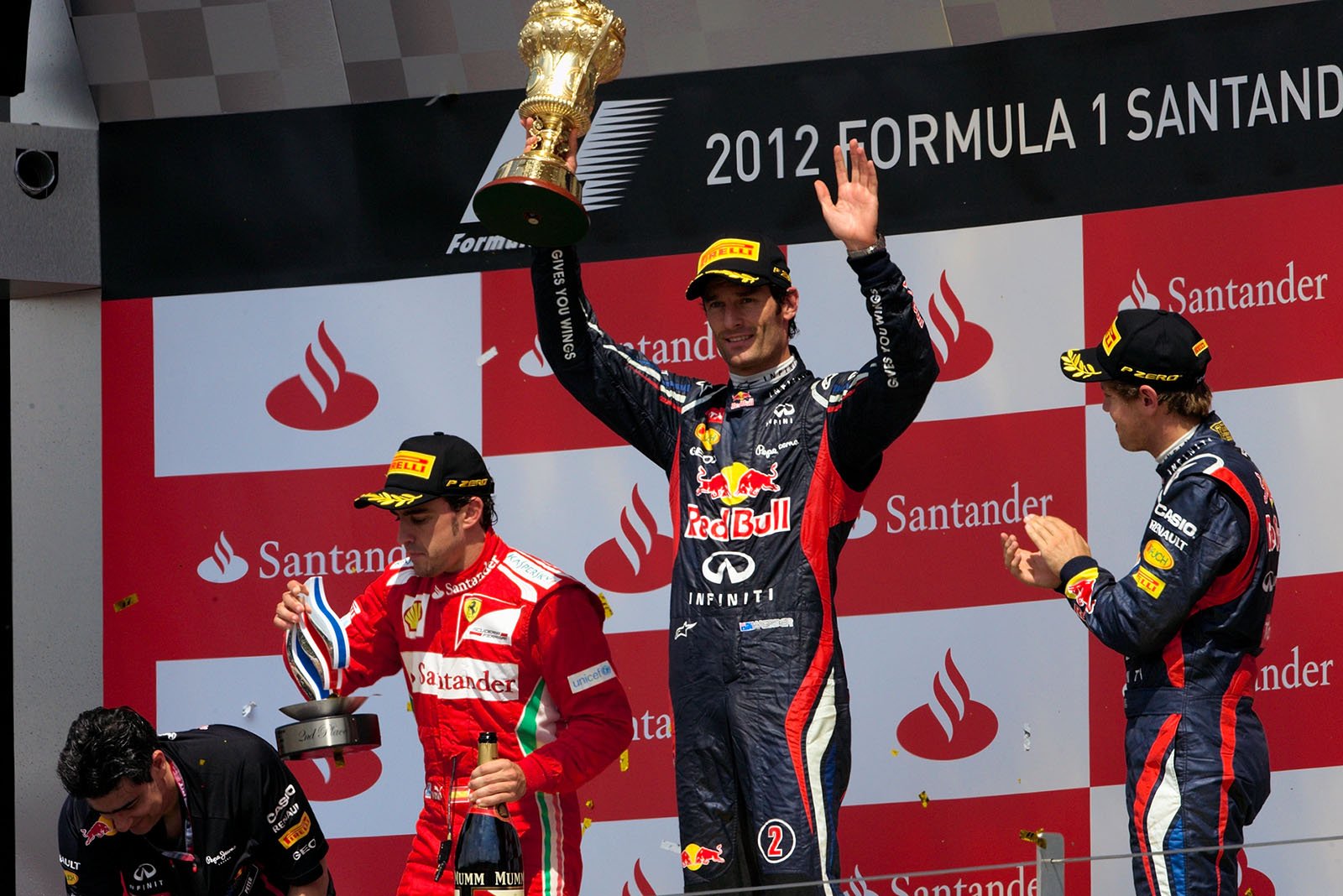 Race winner Mark Webber of Red Bull Racing presents his trophy for the winning driver after the podium ceremony