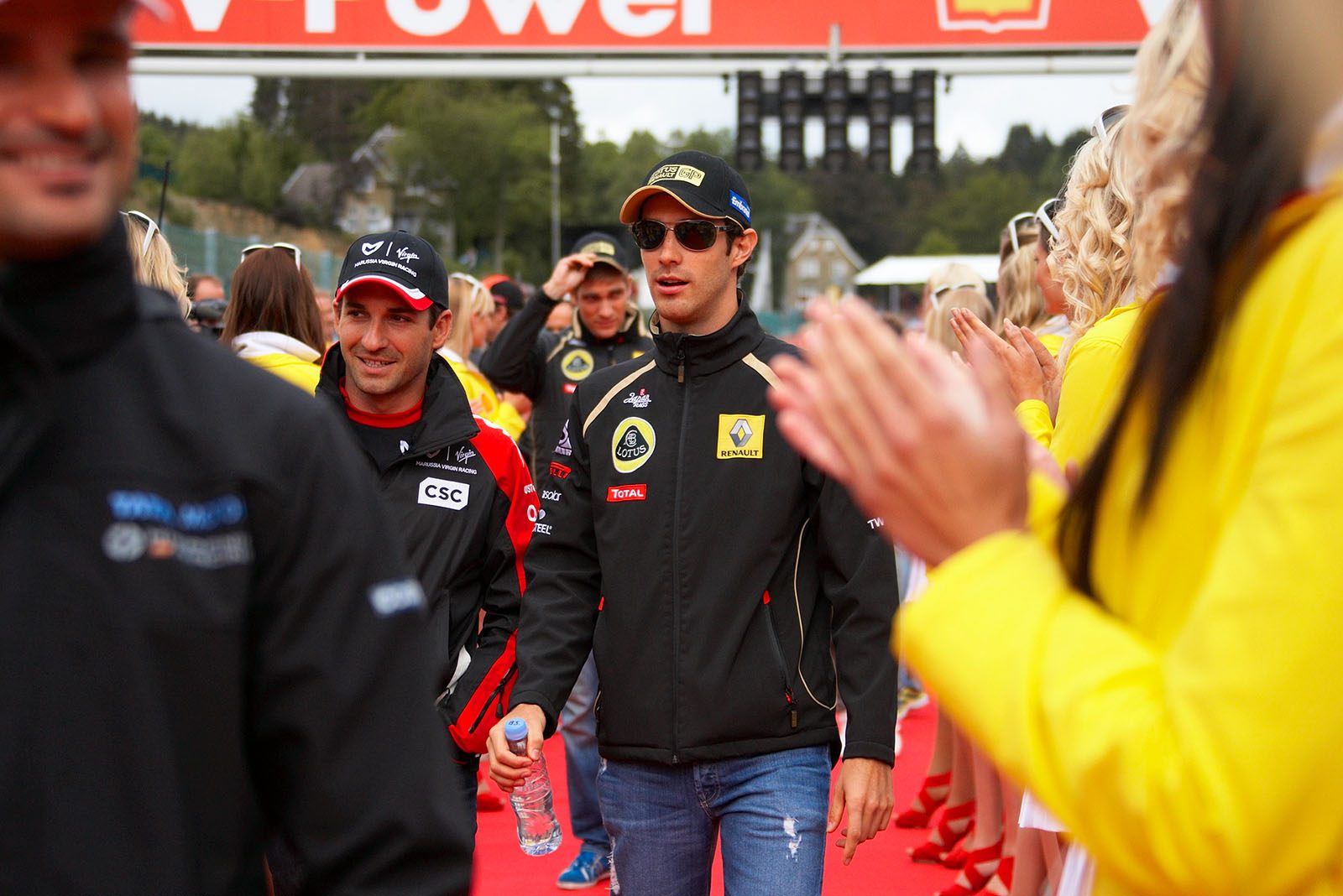 Renault's Bruno Senna walks to drivers parade with Timo Glock