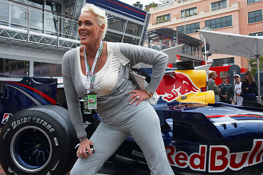 Actress Brigitte Nielsen poses with a sexy Red Bull Racing car