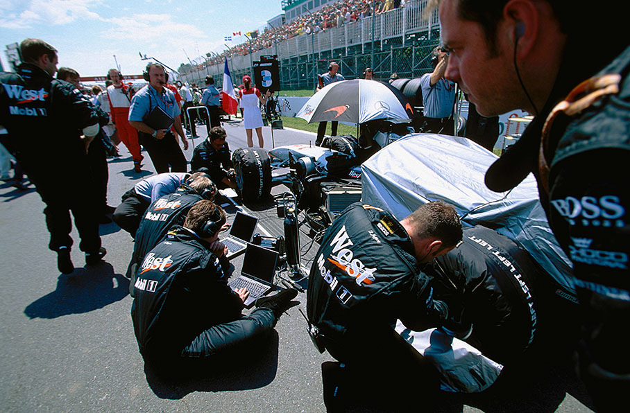 McLaren mechanics at work on the grid