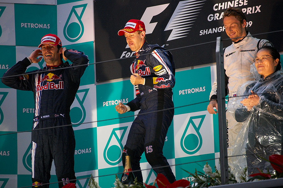 The very happy winner Sebastian Vettel flanked by team mate Mark Webber and third placed Button on podium