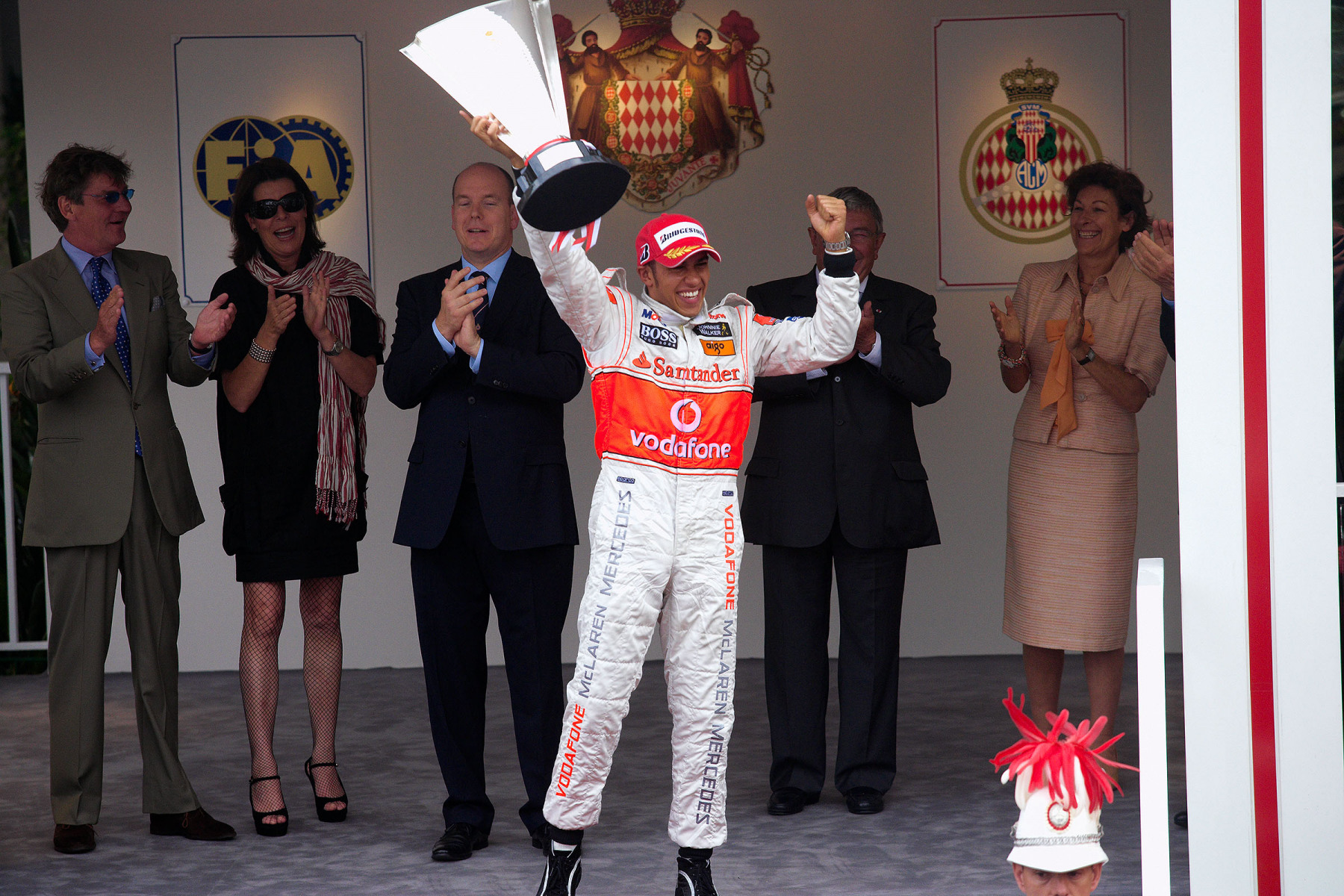Cheerful Lewis Hamilton presents his trophy