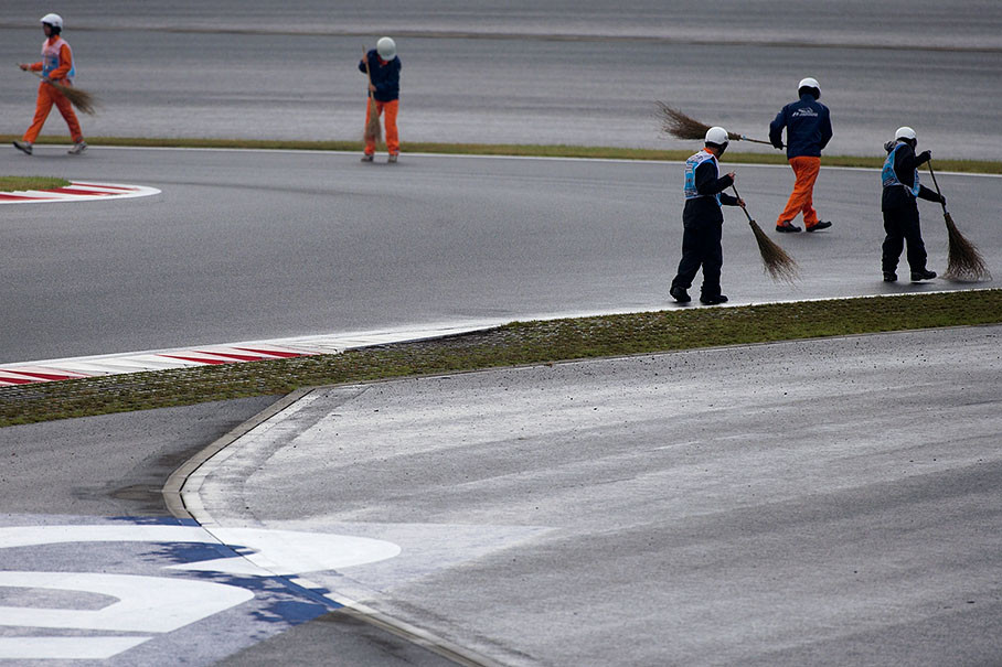 Between the sessions, marshals clean the track from rubber and dirt