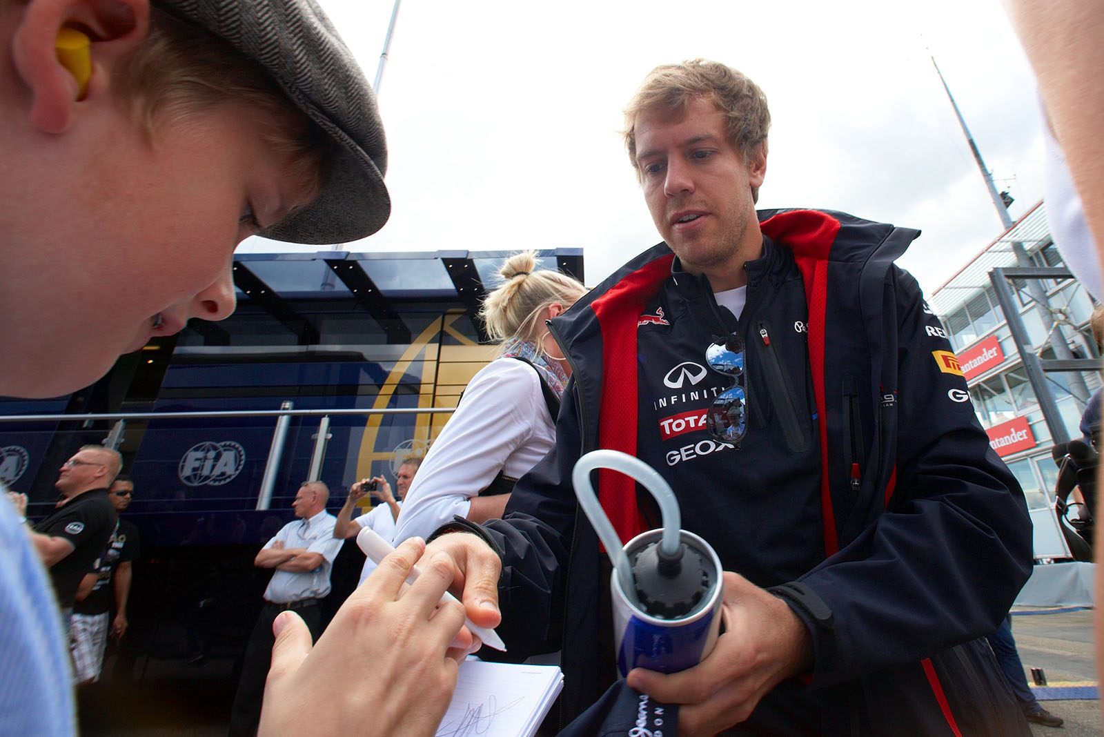 The real Sebastian Vettel gives an autograph