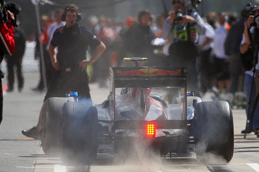 Sebastien Buemi spins the wheels of the Toro Rosso Ferrari during a practice session and raises the dust from pitlane