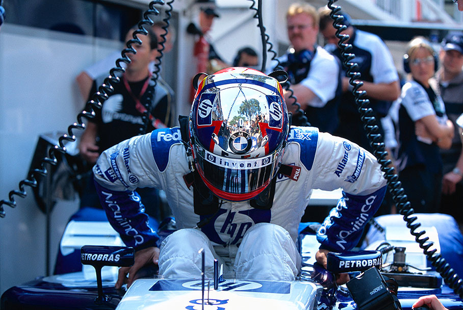 Juan Pablo Montoya squeezes himself into the cockpit of the FW25-BMW P83