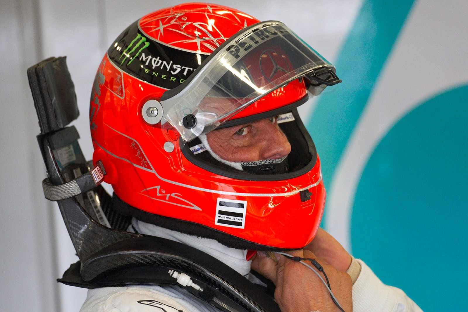 Michael Schumacher, Mercedes GP, puts his helmet on