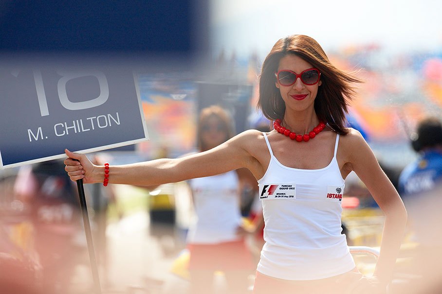 A Turkish grid girl holds a GP2 grid board