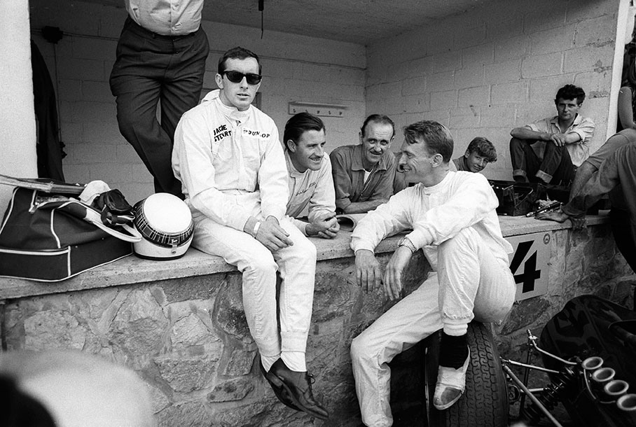 Jackie Stewart, Graham Hill and Dan Gurney have a friendly chat in the BRM pits