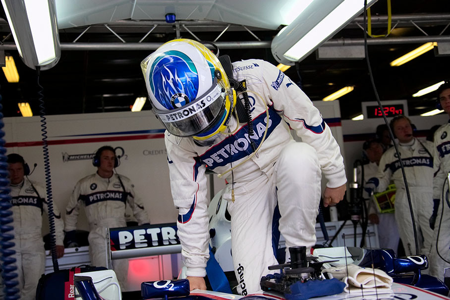Nick Heidfeld jumping into his cockpit