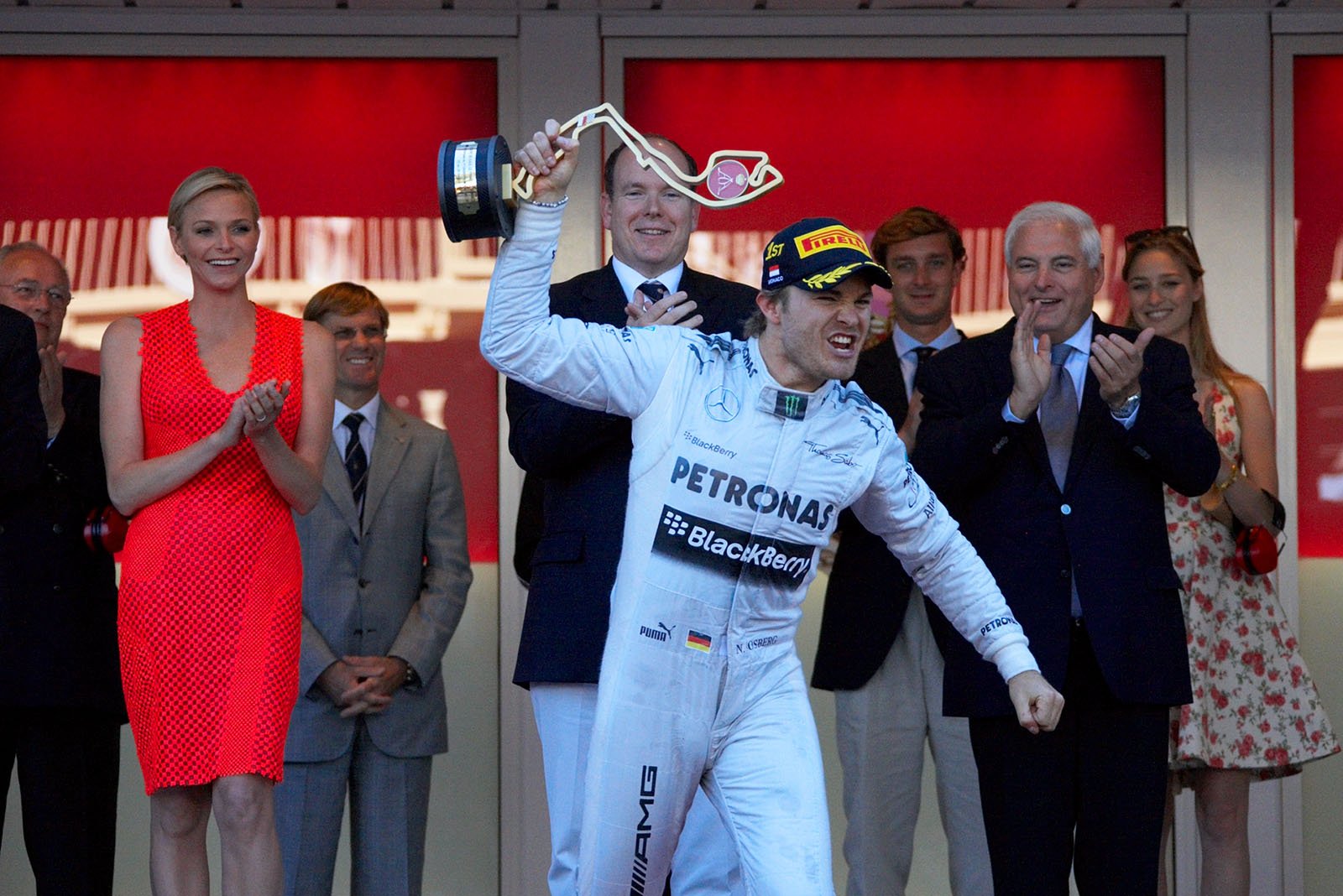 Local hero and race winner Nico Rosberg of Mercedes celebrates his achievement and raises his trophy on the podium